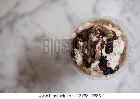 Chocolate Sauce And Whipped Cream On Top Iced Drink With Marble Background