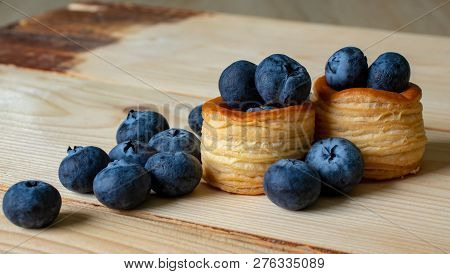 Blueberries With Baskets Of Dough Close-up On Wooden Background