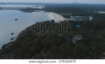 Aerial View Of Beautiful Tropical Beach With Hotel Resort Surrounded By Green Trees. Shot. Paradise 