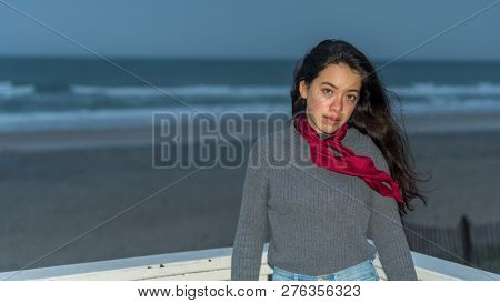 Young Asian-american At North Carolina Beach In Winter With Marron Scarf On Windy Evening