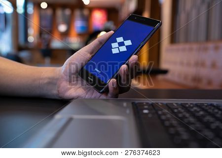Chiang Mai, Thailand - May 05,2018: Man Holding Huawei With Dropbox On Screen. Dropbox Is A Service 