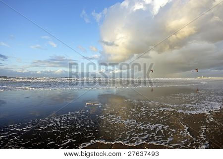 Wide view at the beach in Scheveningen with kitesurfers and de Â´scheveningse pierÂ´ in the background in Holland