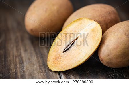 Sapodilla Plum Fruit On Wooden Table, Exotic Thai Fruit (la Mood)