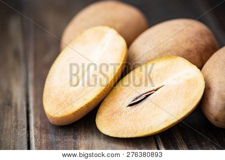 Sapodilla Plum Fruit On Wooden Table, Exotic Thai Fruit (la Mood)