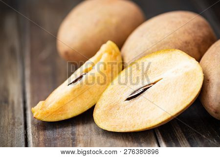 Sapodilla Plum Fruit On Wooden Table, Exotic Thai Fruit (la Mood)