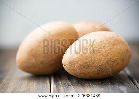 Sapodilla Plum Fruit On Wooden Table, Exotic Thai Fruit (la Mood)