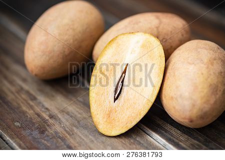 Sapodilla Plum Fruit On Wooden Table, Exotic Thai Fruit (la Mood)