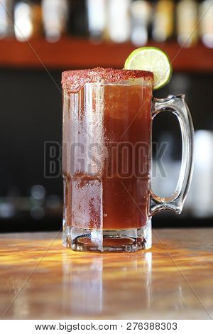 Michelada With Beer In A Glass And Lemon