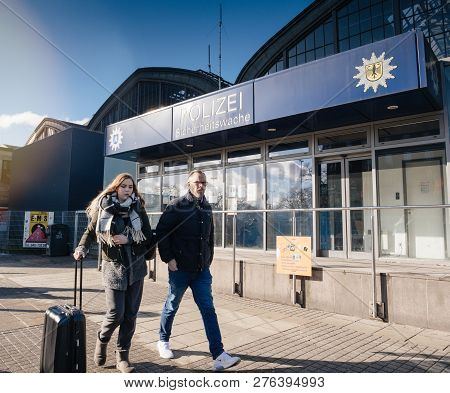 Hamburg, Germany - Mar 20, 2018: Man And Woman Passing By Police Polizei Station Near Hamburg Centra