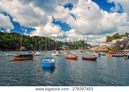 Boats And Yachts On Water At River Harbor On Cloudy Blue Sky In Fowey, Uk. Summer Vacation Concept. 
