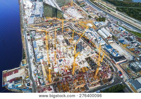 Aerial View Of A Construction Crane Tower. Top View Crane And Building Working Progress. Worker. Con
