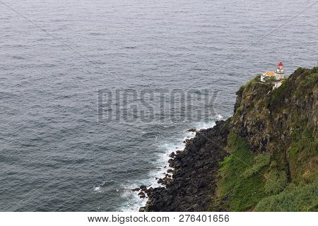 Rocky Cliffs And Rocks Around The Faro Do Arnel Lighthouse On The Island Of Sao Miguel In The Azores