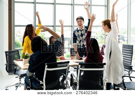 Young Multiethnic Diverse Creative Asian Group Huddle And High Five Hands Together In Office Worksho