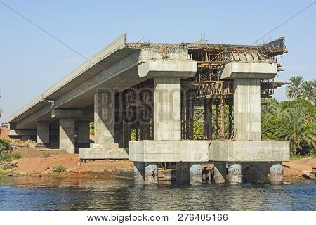 View Of Large Concrete Road Bridge Under Construction Spanning Wide Nile River In Egypt At Kom Ombo