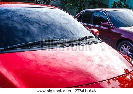 Section Of The Front Of A Red Vehicle And Its Front Windscreen Bonnet And Wipers.