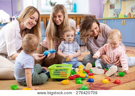 Group Of Mothers With Babies Toddlers At Playgroup