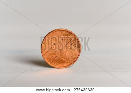 A 2 Cent Euro Coin Standing On A Wooden Background