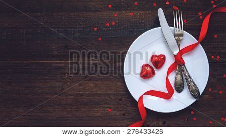 Valentine's Day Festive Table Setting, Flat Lay With Two Red Heart Shape Chocolate Candies On White 
