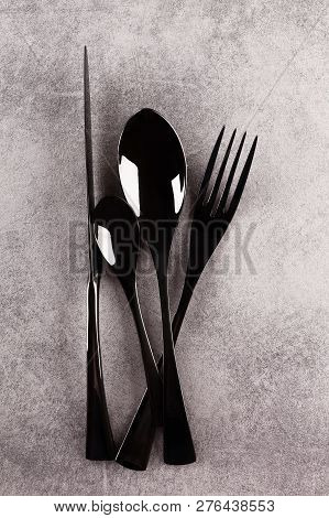 Black Luxurious Modern Cuttlery From Above On Grey Surface. Eating.