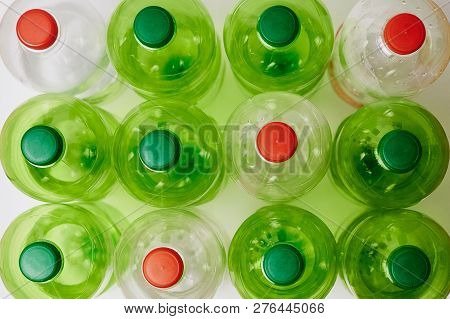 Many Green Plastic Bottles With Caps. Production Of Beverages In Plastic Containers. Problem Of Envi