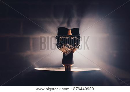 Hookah Bowl With Flawoured Tobacco And Red Hot Coconut Coil On The Black Background With Light. Smok