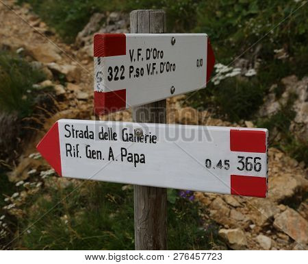 italian trail marker with text that means Road of Tunnels and Alpin hut called A. Papa in Pasubio mountain in Northern Italy