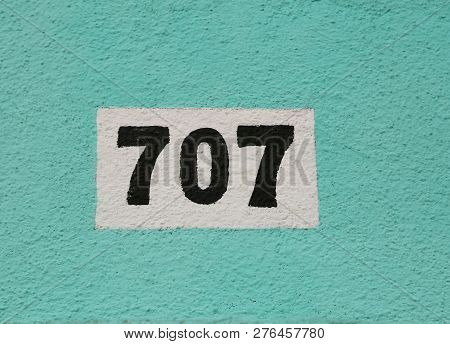 Big Text 707 In Black Ink On The Wall Of An House
