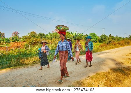 Ava, Myanmar - February 21, 2018: The Group Of Burmese Peasant Women Goes Back After Field Work With