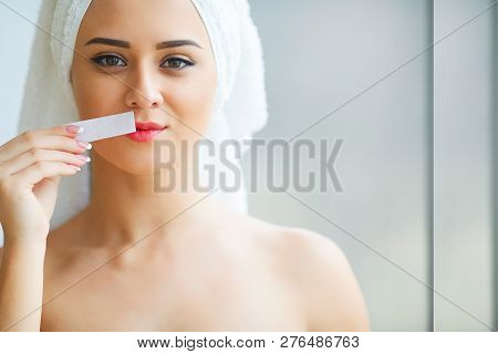 Hair Removal Wax. Young Woman Reciving Facial Epilation
