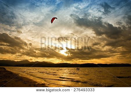 Kitesurfing At Sunset Time On The River In Laredo, Spain.