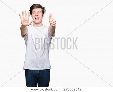 Young handsome man wearing casual white t-shirt over isolated background showing and pointing up with fingers number six while smiling confident and happy.