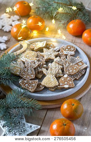 Gingerbread Cookies On A Concrete Tray On A Winter Background With Tangerines, Fir Branches And A Ga