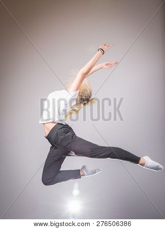 Young Slim Gymnast In Gracefull Jump Studio Shot