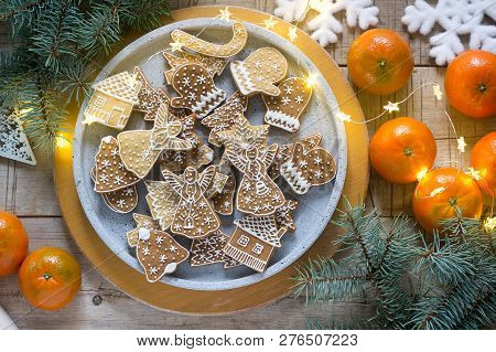 Gingerbread Cookies On A Concrete Tray On A Winter Background With Tangerines, Fir Branches And A Ga