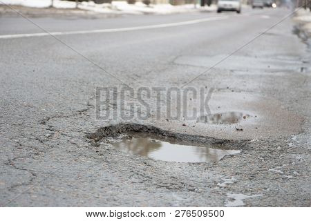 There Are Many Potholes On The Roadway Close Up