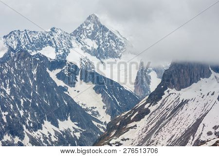 Summer Cloudy Alps Mountain And Bettmerhorn Ridge View From Great Aletsch Glacier And Ice Fall (bett