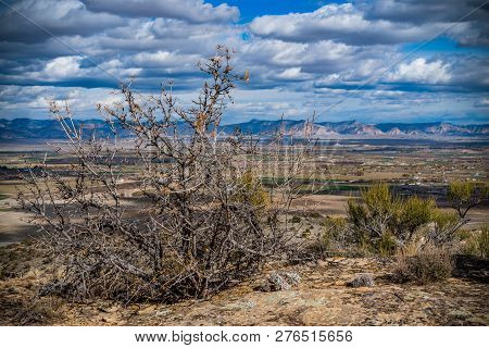 View From Summit Of Mcinnis Canyons In Utah With Blue Sky And Clouds.