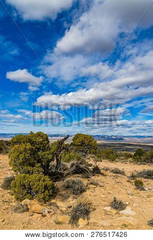 View From Summit Of Mcinnis Canyons In Utah With Blue Sky And Clouds.