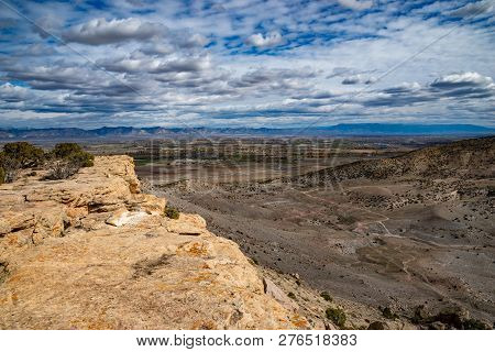 View From Summit Of Mcinnis Canyons In Utah With Blue Sky And Clouds.