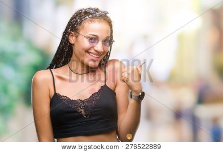 Young braided hair african american with birth mark wearing sunglasses over isolated background doing happy thumbs up gesture with hand. Approving expression looking at the camera with showing success
