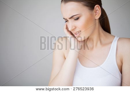 Tooth Pain. Woman Feeling Tooth Pain. Closeup Of Beautiful Sad Girl Suffering From Strong Tooth Pain