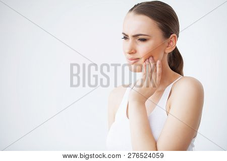 Tooth Pain. Woman Feeling Tooth Pain. Closeup Of Beautiful Sad Girl Suffering From Strong Tooth Pain