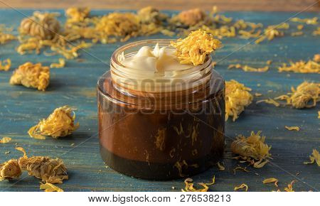 Facial Cream Of Calendula, And Beeswax, On A Wooden Background