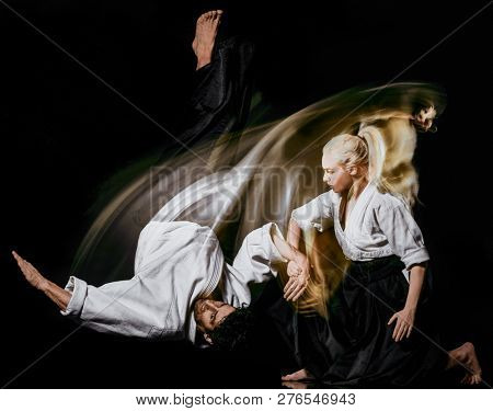 Aikido bodokas man and woman isolated black background