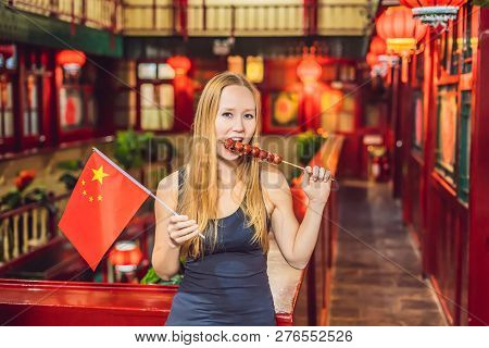 Enjoying Vacation In China. Happy Woman Tourist With A Chinese Flag And With Traditional Chinese Can