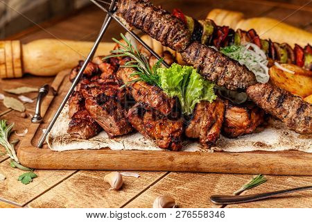 The Concept Of Georgian Cuisine. Meat Board With Shashlik, Grilled Pork Ribs, Lulya Kebab And Shish 