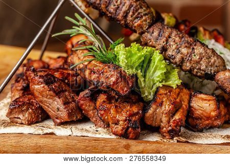 The Concept Of Georgian Cuisine. Meat Board With Shashlik, Grilled Pork Ribs, Lulya Kebab And Shish 