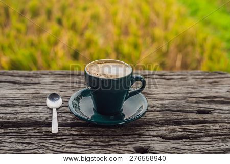 A Cup Of Coffee On The Background Of An Old Wooden Table