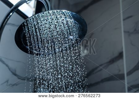 [shower Head] Shower Head In Bathroom With Water Drops Flowing.