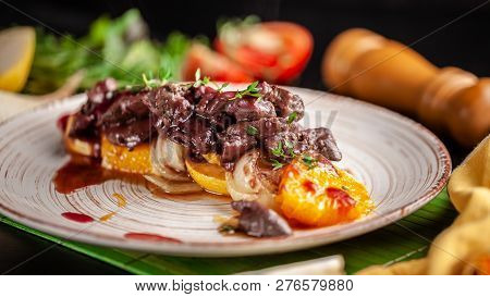 The Concept Of European Cuisine. Grilled Beef Liver With Caramelized Fruit, Pear, Orange And Onion.